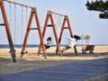 Girls on swings on the beach of Yangyang city