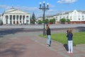 Girls take pictures on central area of Chernihiv. Happy children