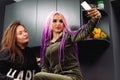 Girls take selfie on smartphone. Interesting cute girlfriends, home in kitchen Royalty Free Stock Photo