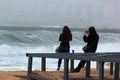 Girls taking photos of a sea storm Royalty Free Stock Photo