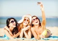 Girls taking self photo on the beach