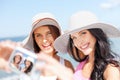 Girls taking self portrait on the beach Royalty Free Stock Photo