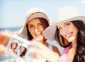 Girls taking self portrait on the beach Royalty Free Stock Photo