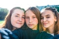 Girls teenage schoolgirls take pictures on a phone, selfie picture, happy smiling, emotions of joy, delight and fun