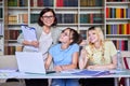 Girls teenage students studying in library with teacher mentor Royalty Free Stock Photo