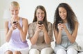 Girls Text Messaging Through Smart Phones In Bedroom Royalty Free Stock Photo