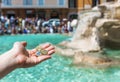 Girls throwing coin at Trevi Fountain for good luck.