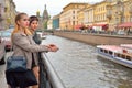 Girls tourists at the gate of the Griboyedov Canal embankment in Royalty Free Stock Photo