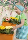 Girls twins of three years care for flowers, Royalty Free Stock Photo