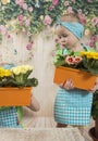 Girls twins of three years care for flowers, Royalty Free Stock Photo