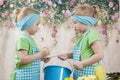 Girls twins of three years care for flowers, Royalty Free Stock Photo