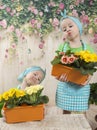 Girls twins of three years care for flowers, Royalty Free Stock Photo