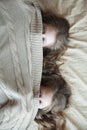 Girls twins watch from under blankets