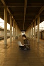 Asian girl sitting on the railway platform