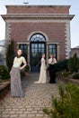 Girls in Victorian outfits in front of old house Royalty Free Stock Photo