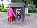 Girls walk near a house in the playground