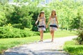 Girls walk in the park and chat with each other