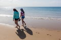 Girls Walking Beach Shoreline Ocean Royalty Free Stock Photo