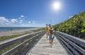 Girls walking on boardwalk on vacation in Florida. Royalty Free Stock Photo