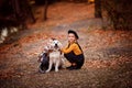 Girls walking Golden Retriever in autumn Park. Royalty Free Stock Photo