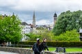 Girls walking at the stree with cityscape of brussels with the landmark of town hall tower against cloudy sky from the Monts des