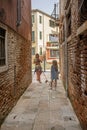 girls walking with their Jack Russell Terrier dog along the streets of Venice i Royalty Free Stock Photo