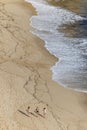 Girls walking on vast sandy beach Royalty Free Stock Photo