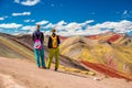 Girls watching stunning view at Palccoyo rainbow mountain Vinicunca alternative, mineral colorful stripes in Andean valley, Royalty Free Stock Photo