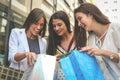 Girls watching their new clothes. Tree best friend enjoying in