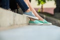 Girls wearing sneakers sitting on stairs Royalty Free Stock Photo