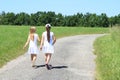 Girls in white dresses on road Royalty Free Stock Photo