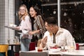 Girls wishing the guy bon appetite and laughing at the fact that he distracting from eating. Royalty Free Stock Photo