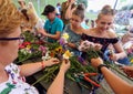 Girls and women making floral wreaths at the annual midsummer festival in Cracow, Poland.