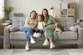 Girls and women of three family generations sitting at dog Royalty Free Stock Photo