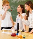 Girls working in chemistry laboratory with liquid formula Royalty Free Stock Photo