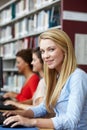 Girls working on computers in library Royalty Free Stock Photo