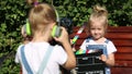 Children with photo appart in a city park.