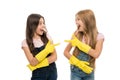 Girls with yellow rubber protective gloves ready for cleaning. Household duties. Little helper. Girls cute kids love