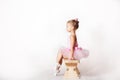 Girls - young ballerinas in pink dresses on a light background