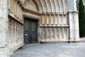 Girona catherdral, Spain. An ornate gothic doorway with arches surrounding a heavy wooden door. Royalty Free Stock Photo