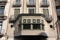 Girona, Spain, August 2016. A fragment of an interesting old building with stained glass on the balcony.