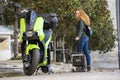 Girona, Spain, October 25, 2022. Woman removing the battery from a Silence Electric motorcycle