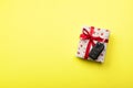 Give gift car key concept top view. Present box with red ribbon bow, heart and car key on yellow colored background Royalty Free Stock Photo