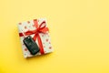 Give gift car key concept top view. Present box with red ribbon bow, heart and car key on yellow colored background Royalty Free Stock Photo