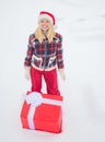 Give gift. Christmas Woman holding a huge gift box - full length. Happy woman standing on white snow background and Royalty Free Stock Photo