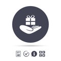 Give a gift sign. Hand holds present box. Royalty Free Stock Photo