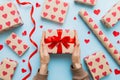 Give a gift on Valentine Day.Valentine gift. Beauty Woman hands holding Gift box with red bow over holiday background Royalty Free Stock Photo