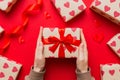 Give a gift on Valentine Day.Valentine gift. Beauty Woman hands holding Gift box with red bow over holiday background Royalty Free Stock Photo