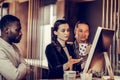 Serious brunette girl pointing at screen of computer