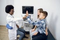 Give me high five. Friendly smiling African American lady professional doctor gives hign five to cute 10-aged schoolboy